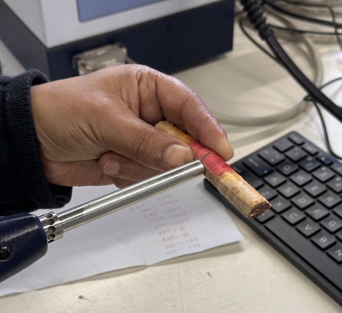 Sanded face of core is scanned with NIR to evaluate heartwood quality (extractive content) at the School of Forestry, University of Canterbury 